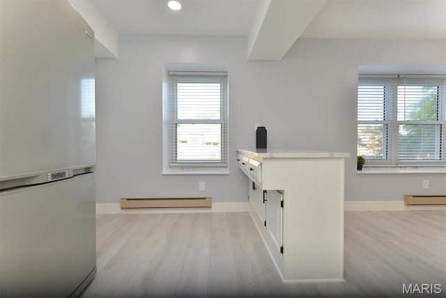 1680 Herault Pl Unit F, Saint Louis, MO 63125 - interior space featuring a baseboard heating unit, wood finished floors, baseboards, and recessed lighting