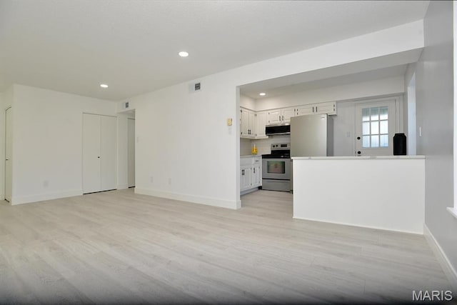 1680 Herault Pl Unit F, Saint Louis, MO 63125 - unfurnished living room with light wood finished floors, recessed lighting, and baseboards