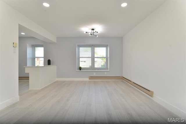 1680 Herault Pl Unit F, Saint Louis, MO 63125 - empty room with a baseboard heating unit, light wood-style flooring, recessed lighting, and baseboards
