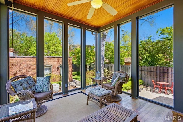 sunroom / solarium featuring ceiling fan and healthy amount of natural light