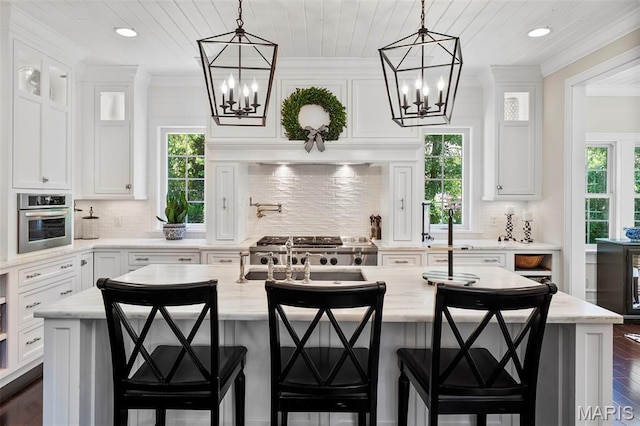 1178 Turnberry Dr, Innsbrook, MO 63390 - kitchen with a chandelier, white cabinets, tasteful backsplash, recessed lighting, and ornamental molding