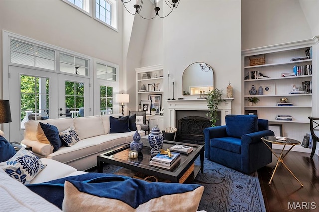 1178 Turnberry Dr, Innsbrook, MO 63390 - living area with wood-type flooring, a high ceiling, built in shelves, and a fireplace