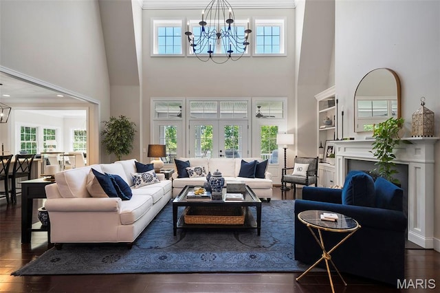 1178 Turnberry Dr, Innsbrook, MO 63390 - living area with a chandelier, a high ceiling, hardwood / wood-style flooring, a fireplace, and ornamental molding