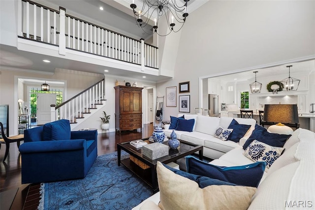 1178 Turnberry Dr, Innsbrook, MO 63390 - living room featuring a chandelier, wood finished floors, healthy amount of natural light, ornamental molding, and a high ceiling