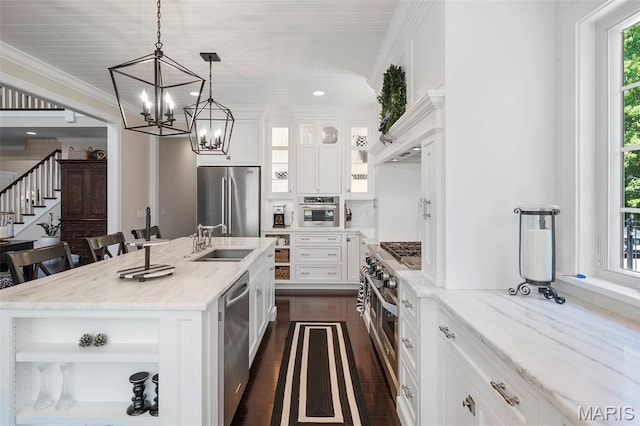 1178 Turnberry Dr, Innsbrook, MO 63390 - kitchen featuring appliances with stainless steel finishes, a sink, a chandelier, white cabinetry, and glass insert cabinets