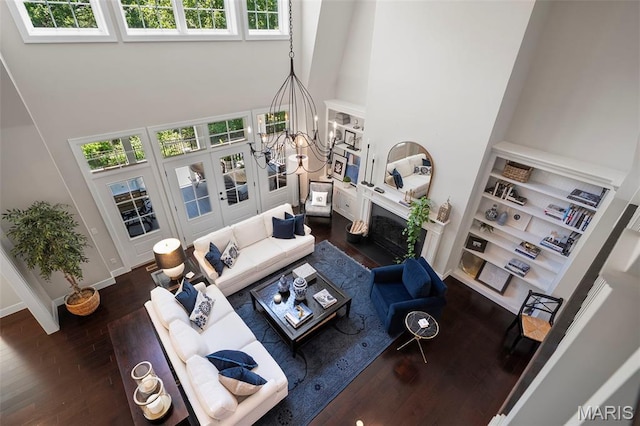1178 Turnberry Dr, Innsbrook, MO 63390 - living room with a towering ceiling, dark wood finished floors, french doors, and a fireplace with flush hearth