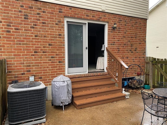 2128 Friendship Ct, Florissant, MO 63031 - view of exterior entry with brick siding and a patio
