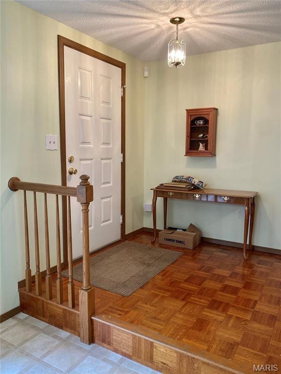 2128 Friendship Ct, Florissant, MO 63031 - foyer with a chandelier and a textured ceiling