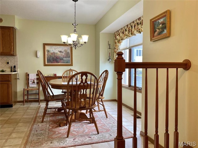 2128 Friendship Ct, Florissant, MO 63031 - dining room with a chandelier and baseboards