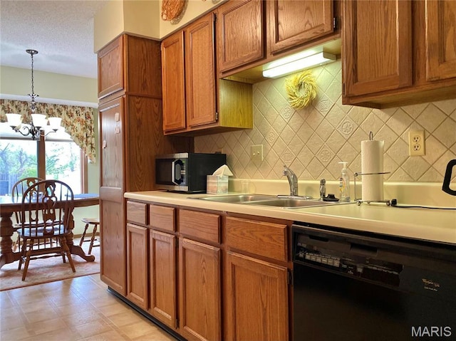 2128 Friendship Ct, Florissant, MO 63031 - kitchen featuring dishwasher, brown cabinetry, a chandelier, decorative backsplash, and hanging light fixtures
