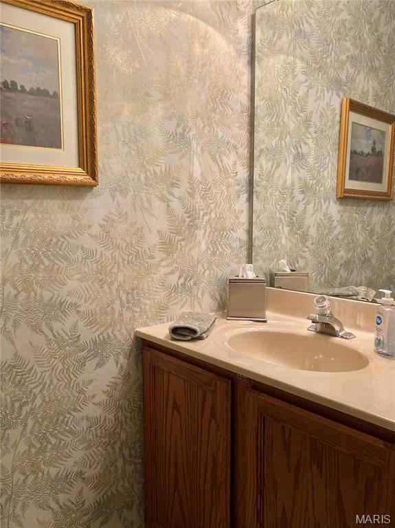 2128 Friendship Ct, Florissant, MO 63031 - bathroom with vanity and wallpapered walls