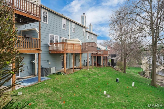 3110 Autumn Shores Dr, Maryland Heights, MO 63043 - back of house with a chimney, a yard, central AC unit, and a wooden deck