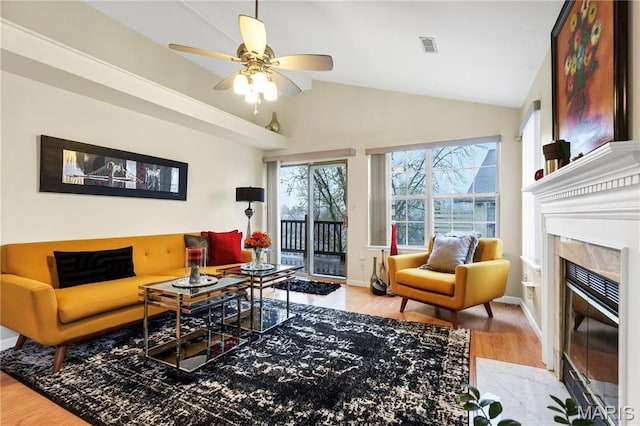 3110 Autumn Shores Dr, Maryland Heights, MO 63043 - living room with wood finished floors, a fireplace, vaulted ceiling, ceiling fan, and baseboards