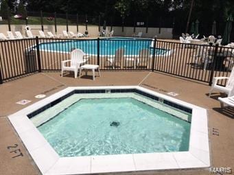 3110 Autumn Shores Dr, Maryland Heights, MO 63043 - community pool with fence, a hot tub, and a patio area