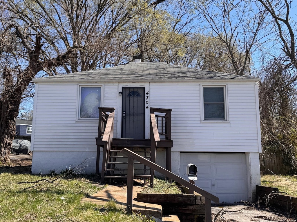4304 Springdale Ave, Saint Louis, MO 63134 - view of front facade featuring an attached garage and a shingled roof
