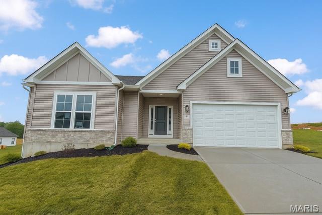 219 Kreder Ln, Saint Charles, MO 63304 - view of front facade featuring concrete driveway, a front lawn, and a garage