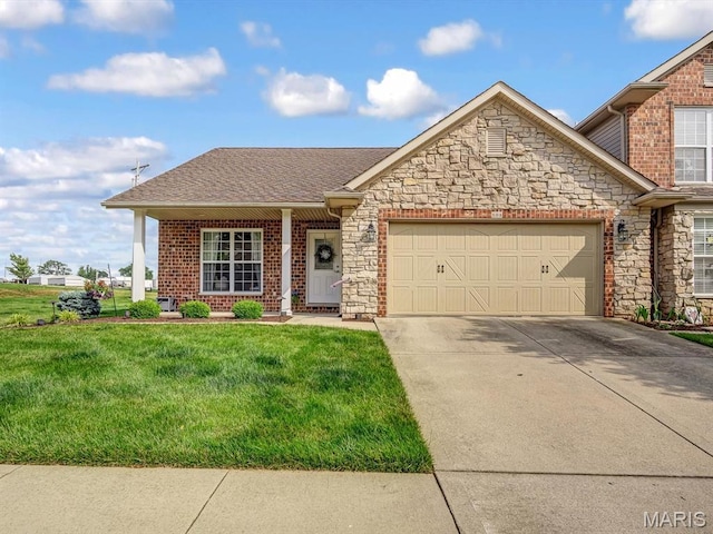 508 Southview Dr, Waterloo, IL 62298 - view of front of house with an attached garage, driveway, a front lawn, and stone siding