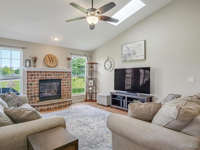 508 Southview Dr, Waterloo, IL 62298 - living area with vaulted ceiling, a ceiling fan, wood finished floors, a fireplace, and a skylight