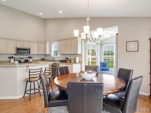 508 Southview Dr, Waterloo, IL 62298 - dining area with light wood-style flooring, high vaulted ceiling, a chandelier, baseboards, and recessed lighting