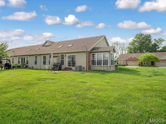 508 Southview Dr, Waterloo, IL 62298 - rear view of house featuring a lawn, a shingled roof, stone siding, and central air condition unit