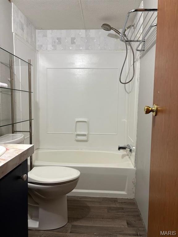 8336 Cedar Fork Rd, New Haven, MO 63068 - bathroom with toilet, wood finished floors, tub / shower combination, vanity, and a textured ceiling