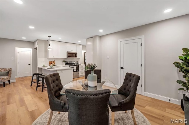 83 Chafford Woods, Saint Louis, MO 63144 - dining area with light wood finished floors and recessed lighting