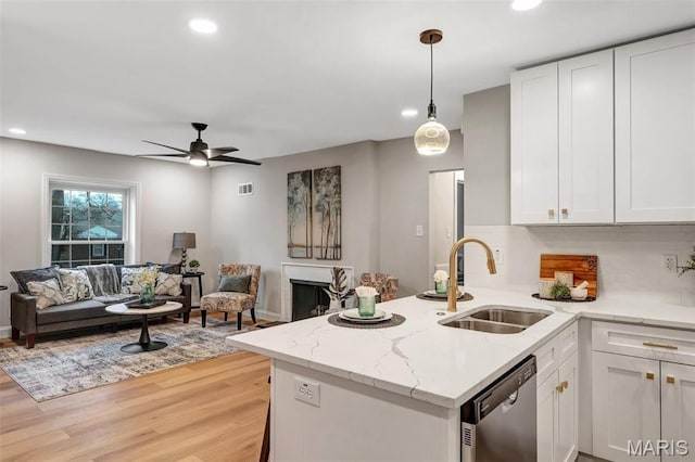83 Chafford Woods, Saint Louis, MO 63144 - kitchen featuring stainless steel dishwasher, recessed lighting, white cabinetry, open floor plan, and light wood-style flooring