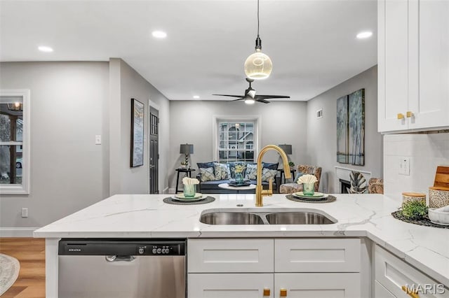 83 Chafford Woods, Saint Louis, MO 63144 - kitchen with dishwasher, white cabinets, light wood finished floors, a ceiling fan, and light stone counters
