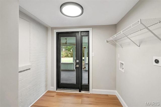 83 Chafford Woods, Saint Louis, MO 63144 - washroom featuring light wood-type flooring, hookup for a washing machine, hookup for an electric dryer, and brick wall
