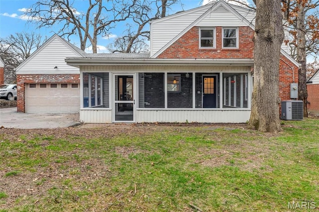 83 Chafford Woods, Saint Louis, MO 63144 - view of front of property featuring a sunroom, brick siding, a garage, and a front yard