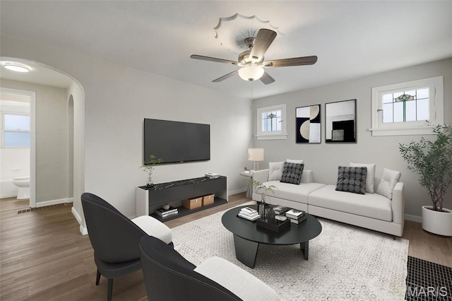 9515 Edmund Ave, Saint Louis, MO 63114 - living room with wood finished floors, ceiling fan, and arched walkways