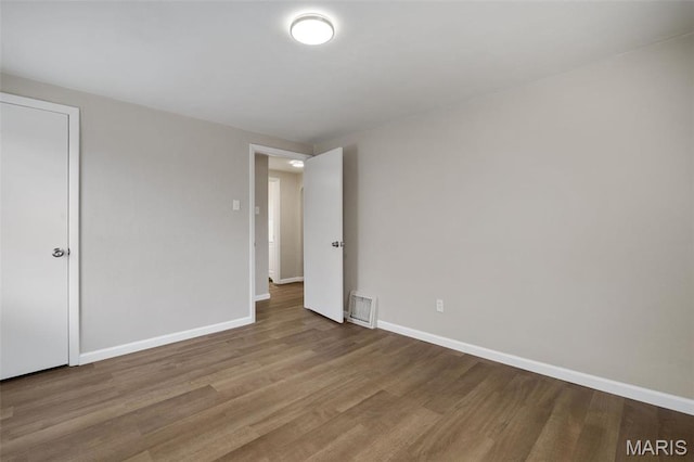 9515 Edmund Ave, Saint Louis, MO 63114 - empty room with wood finished floors and baseboards