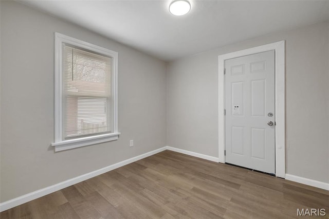 9515 Edmund Ave, Saint Louis, MO 63114 - empty room with healthy amount of natural light and wood finished floors