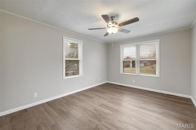 9515 Edmund Ave, Saint Louis, MO 63114 - spare room with healthy amount of natural light, ornamental molding, a ceiling fan, wood finished floors, and a textured ceiling