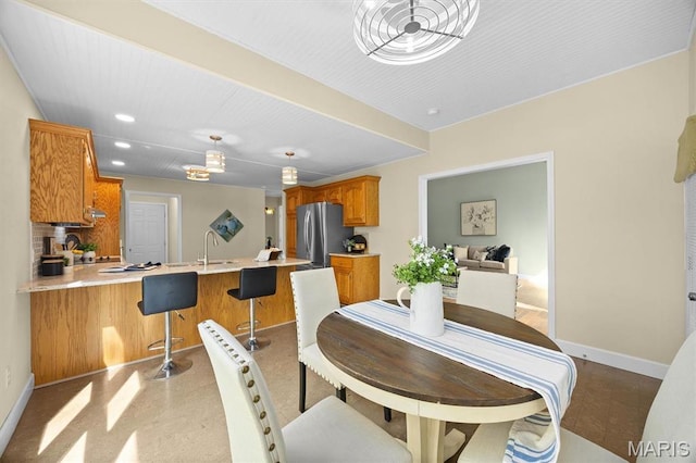 dining area featuring baseboards and recessed lighting