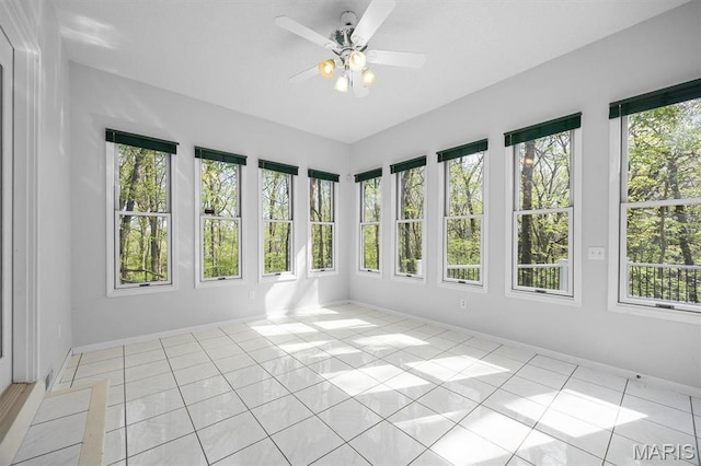 unfurnished sunroom featuring tile patterned floors and baseboards
