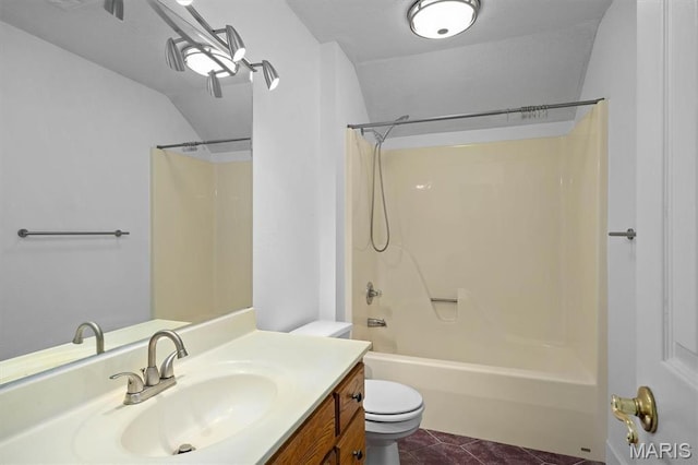 bathroom with toilet, lofted ceiling, bathing tub / shower combination, vanity, and tile patterned flooring