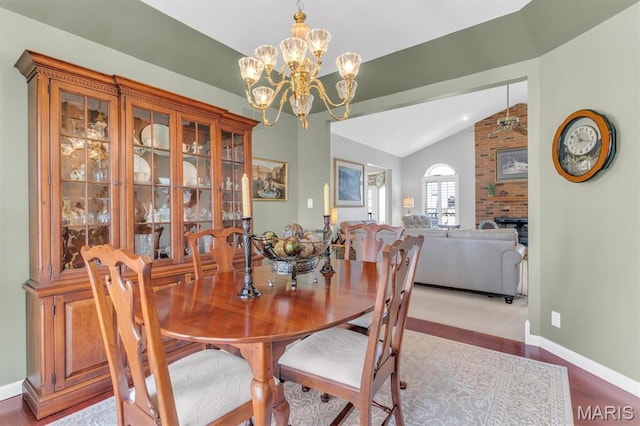 13463 Keller Ridge Cv, Saint Louis, MO 63128 - dining space featuring lofted ceiling, a chandelier, baseboards, a fireplace, and ceiling fan