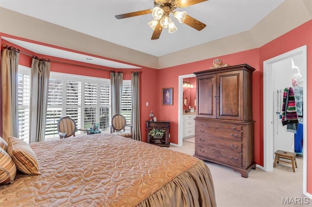 13463 Keller Ridge Cv, Saint Louis, MO 63128 - bedroom featuring light carpet, a spacious closet, baseboards, ceiling fan, and ensuite bathroom