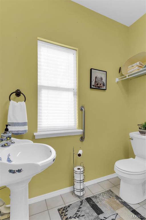 13463 Keller Ridge Cv, Saint Louis, MO 63128 - half bath featuring tile patterned flooring, toilet, and baseboards