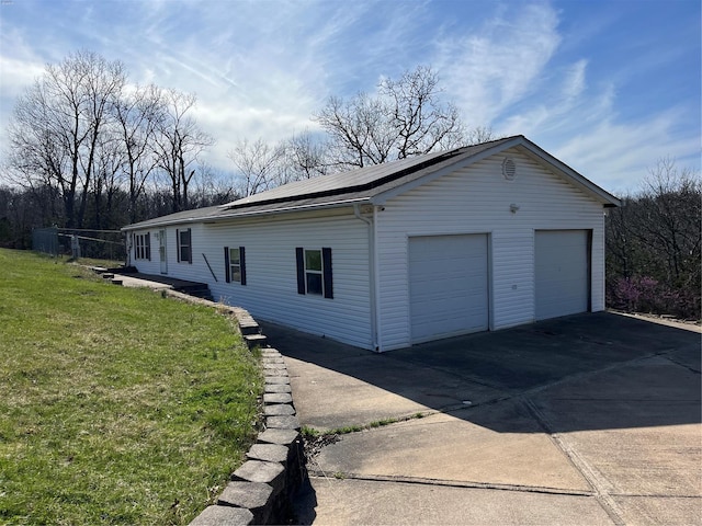 2717 Creon Ct, De Soto, MO 63020 - view of side of property with a garage, roof mounted solar panels, and a lawn