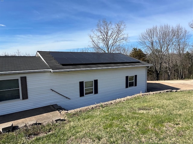 2717 Creon Ct, De Soto, MO 63020 - view of home's exterior featuring solar panels, a lawn, and a shingled roof