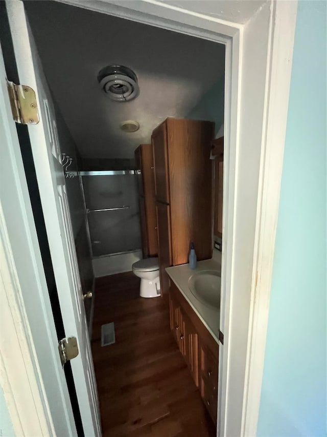 2717 Creon Ct, De Soto, MO 63020 - bathroom featuring a shower with door, wood finished floors, toilet, and vanity