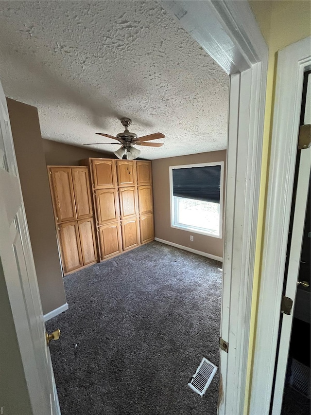 2717 Creon Ct, De Soto, MO 63020 - unfurnished bedroom with baseboards, carpet, a textured ceiling, and ceiling fan