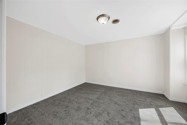 1300 Hudson Rd, Saint Louis, MO 63135 - spare room featuring dark carpet and baseboards