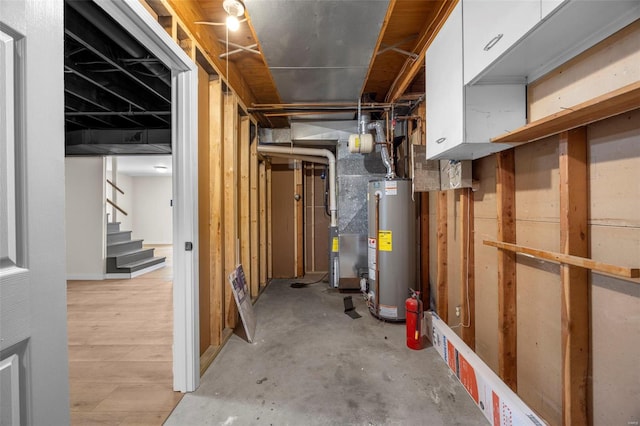 1300 Hudson Rd, Saint Louis, MO 63135 - unfinished basement with water heater and stairs
