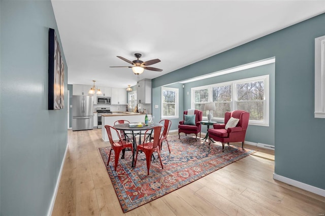 1300 Hudson Rd, Saint Louis, MO 63135 - dining space with baseboards, light wood-type flooring, ceiling fan, and a chandelier
