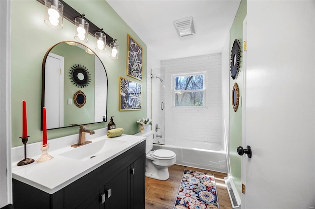 1300 Hudson Rd, Saint Louis, MO 63135 - bathroom featuring wood finished floors, toilet, vanity, and shower / bathtub combination