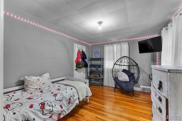 bedroom featuring light wood-type flooring and baseboards