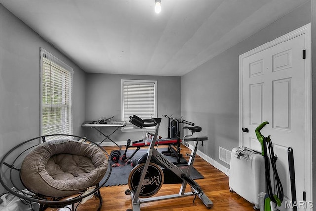 workout area with wood finished floors and baseboards